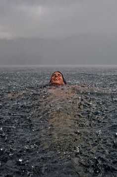 a person floating in the water with their eyes closed