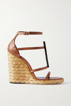 SAINT LAURENT's 'Cassandra' sandals are a sophisticated choice for your next summer party. Made in Italy, they're topped with supple brown leather straps accented by iconic logo hardware and rest on supportive jute wedges - a perfect match for the brand's 'Envelope' bag. How To Style Espadrilles, Style Espadrilles, Latest Sandal, Brown Wedge Sandals, Ankle Strap Wedges, Black Espadrilles, Brown Leather Sandals, Black Wedge Sandals, Saint Laurent Shoes