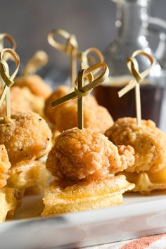 small appetizers are arranged on a plate with toothpicks in the shape of crosses