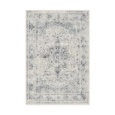 ruggable's blue and white area rug with an ornate design on it