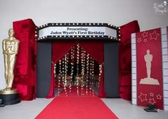 a red carpeted entrance to an oscars ceremony with statues and lights on it