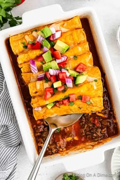 a white casserole dish filled with mexican food