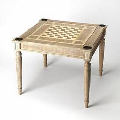 an old wooden table with a checkerboard design on the top and two legs