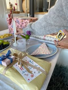 a table topped with plates and boxes filled with food