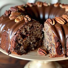 a chocolate cake with pecans on top and one slice cut out from the cake