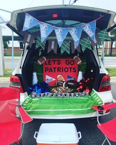 the tail end of a sports themed car with an american flag and football decorations on it