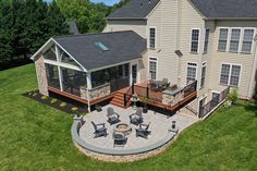 an aerial view of a large house with patio and seating area in the middle of it