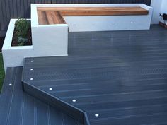 a wooden bench sitting on top of a deck