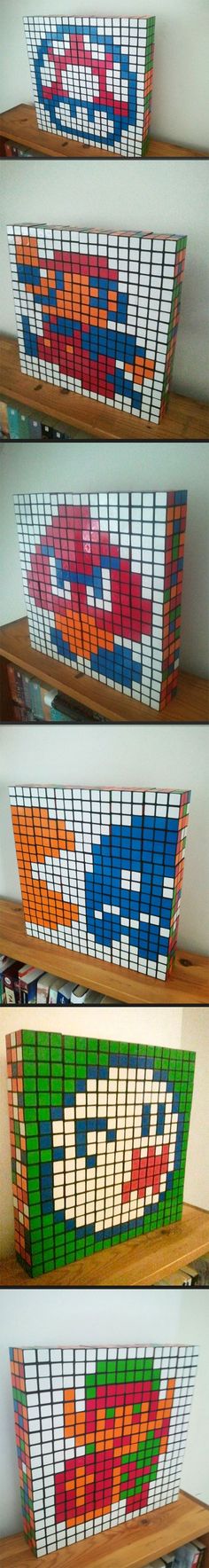 four different colored bookshelves sitting on top of a wooden shelf next to each other