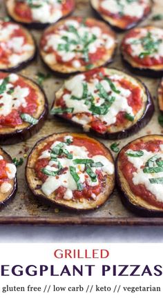 grilled eggplant pizzas on a baking sheet with cheese and green garnish