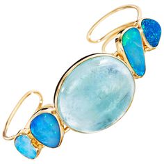 A one-of-a-kind cuff bracelet of an oval cabochon aquamarine and four boulder opals, handcrafted in 18 karat yellow gold. This gorgeous cuff bracelet features a large luminous oval cabochon aquamarine as the center stone, flanked by two vibrant boulder opals on either side. This elegant wrist candy brings a touch of brilliant blue colors to your look. Yellow Gold Cuff Bracelet, Opal Cuff Bracelet, Wired Jewelry, Stone Jewellery Designs, Statement Cuff Bracelet, Diamond Cuff Bracelet, Gold Cuff Bracelet, Modern Bracelets, Wrist Candy