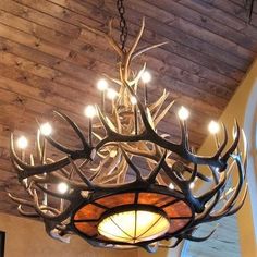 a deer antler chandelier hanging from the ceiling