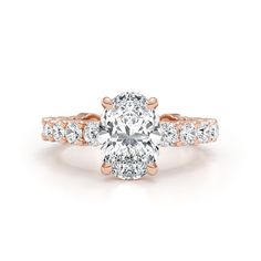 an oval cut engagement ring with two rows of diamonds on the band