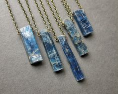 Imperial Kyanite Necklace: Carry a piece of the earth's beauty with you wherever you go! This striking crystal pendant is the perfect gift for yourself or your favorite crystal lover! ✧ Hand selected imperial kyanite ✧ Natural semi-polished crystal, NOT treated or dyed ✧ Crystal size 12-30mm long (mini and small crystals are smaller than the ones shown in the other photos) ✧ Select your favorite crystal from the dropdown menu ✧ Antique brass chain in your chosen length ✧ Hypoallergenic metals up Blue Outfit Ideas, Fidget Jewelry, Kyanite Necklace, Witchy Boho, Diy Jewelry Making Tutorials, Kyanite Jewelry, Green Kyanite, Pebble Necklace, Raw Stone Necklace