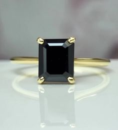 a black diamond ring on a white surface