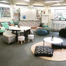 a living room filled with furniture and lots of pillows on top of carpeted flooring