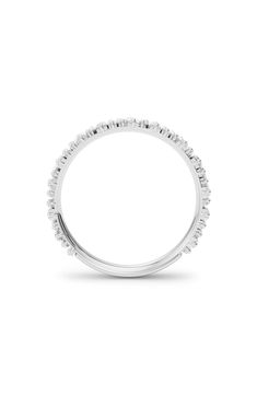 a white gold wedding band with round cut diamonds on the sides and an oval shaped center