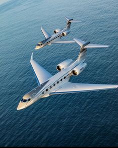 three planes flying in the air over water