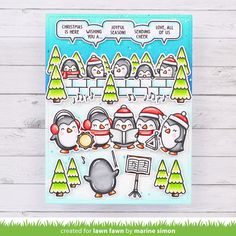 a christmas card with penguins and trees