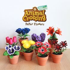 several potted plants with fake flowers in front of the sign for an animal crossing