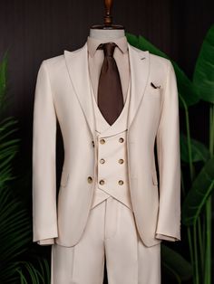 Color: beige Material: 73% polyester, 23% viscose, 4% elastane Suit includes blazer, waistcoat, & trousers Single-breasted suit (2-button blazer) Lapel type: peak lapels Jacket interior lining option: fully-lined Jacket vent: double vent Fitting: modern-fit Care instructions: dry clean only Machine washable: no 3 Piece Suit Men Classy, 3 Piece Suit Men, Blazer Waistcoat, Bow Tie Suit, Modern Fit Suit, Cream Suit, Suit Stores, Suit Styles, Slim Fit Suit Men