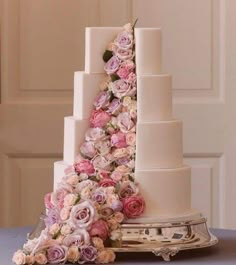 a wedding cake with pink and white flowers on it