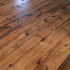 an empty room with wooden floors and hard wood flooring on one side, looking like it has been cleaned