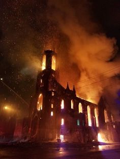 a large building that is on fire in the night