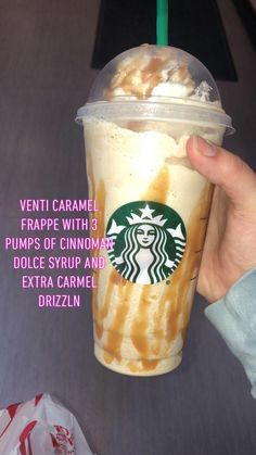 a person holding up a starbucks drink with caramel and whipped cream in it's cup