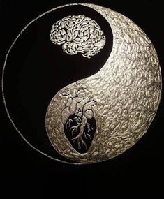 a metal yin - yang symbol with two hearts in the middle and one brain on it