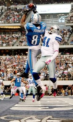 two football players jumping up in the air