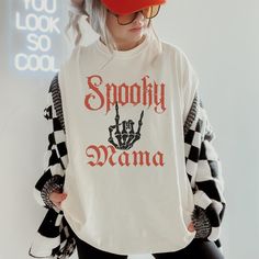 This Spooky Mama Halloween Shirt is perfect for Halloween or all year long. Its fun whimsigoth lettering will show your fun alt Mom style. Comfort Colors are the most popular and trending shirts right now. This shirt will soon be your favorite with fabric created to be softer and feel broken in. The elevated dyeing process reduces shrinking up to 99% and the shirt is made from 100% ring spun cotton. - M A T E R I A L S - 100% ring-spun cotton Medium fabric (6.1 oz/yd² (206.8 g/m Relaxed fit Sewn Spooky White Tops For Streetwear, Spooky White Tops With Screen Print, White Spooky Tops For Streetwear, Spooky White Top With Screen Print, White Halloween Letter Print Top, Oversized White T-shirt For Halloween, Spooky White Graphic Print Top, Mama Halloween Shirts, White Long Sleeve T-shirt For Halloween