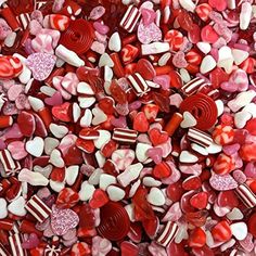 red and white candy hearts are scattered on top of each other