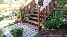 a wooden stair case next to some plants