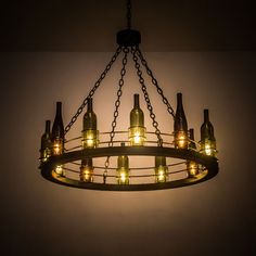 a chandelier made out of wine bottles is lit up by the light bulbs