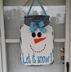 a door hanger with a snowman face on it