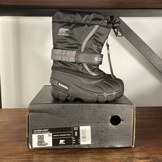 These Sorel Boots Are New In Box. Color On Box Is Black/City Gray. Style Is “Flurry “. Size 8 (Toddler). New With Tags And Box. Please See Close-Up Picture Of One Boot Where There Appears To Be A Pin Prick Hole At The Top Where A Security Tag Was Attached. Non-Smoking Home. **Please Note I Will Wrap Box In Brown Shipping Paper To Mail. Black City, Sorel Boots, Close Up Pictures, Box Color, Rain And Snow Boots, Snow Boots, Black Gray, Close Up, Black And Grey