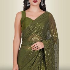 Introducing the One Minute Sequin Saree in Dark Green, a masterpiece crafted from luxurious georgette. This saree is not just a garment; it's an experience in effortless elegance. With a pre-stitched blouse that guarantees a perfect fit, getting ready has never been this convenient.The saree belt adds a touch of grace and sophistication to your ensemble, transforming you into the epitome of style in minutes. The mesmerizing sequin work catches the light in all the right ways, ensuring you shine Fitted Georgette Pre-draped Saree For Celebration, Georgette Saree With Unstitched Blouse For Celebration, Celebration Georgette Saree With Unstitched Blouse, Green Georgette Blouse With Mirror Work, Festive Georgette Blouse For Celebration, Bollywood Style Pre-draped Georgette Saree For Celebration, Festive Celebration Georgette Blouse, Festive Pre-draped Georgette Saree For Celebrations, Festive Celebration Pre-draped Georgette Saree