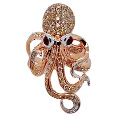 This unique ring is an art on finger. The intricate details of this octopus ring will leave you speechless. The octopus body is made of 18k rose gold with the ruby cabochon eyes that are set in 18k white gold. The diamonds are set in a pavé set throughout the tentacles and head. This is a fabulous , whimsical piece for your collection! Ring Size: 7 (can be resize) Diamonds: 1.62 cts, Round Brilliant Rubies: 0.23 ct, Cabochon Metal: 18k Rose & White Gold Tentacles Ring, Octopus Ring, Ring With Stone, The Octopus, Cool Jewelry, Unique Ring, Cocktail Rings, Unique Rings, 18k Rose Gold