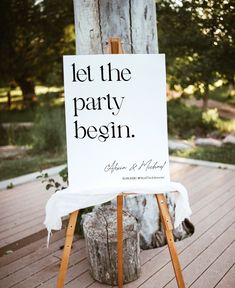 a welcome sign on an easel for a wedding