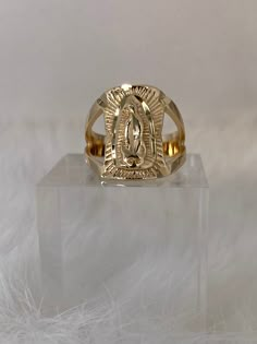 The Cutout Virgin Mary Ring is a showpiece! This unique ring brings remembrance to the miraculous birth of Jesus. And the angel said unto her, "thou shalt bring forth a son, and shalt call his name JESUS. He shall be great, and shall be called the Son of the Highest." This stylish religious ring features a statement diamond cut unisex Virgin Mary framed by two cutout bands. This piece is great for both men and women. Available in 24K gold or rhodium plating over steel Patent plating & sealant te Catholic Gold Ring, Jewelry Virgin Mary, Virgencita Ring, Virgin Mary Ring Gold, Gold Rings Virgin Mary, Virgin Mary Ring, Gold Virgin Mary Necklace, Religious Rings, Gold Pendants For Men