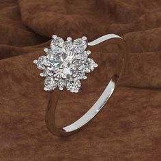 a diamond ring on top of a brown cloth