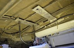 the underside of a vehicle with wires attached to it's sides and an exhaust ventilator