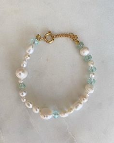 The Crystal Bracelet is made of freshwater pearls, small colorful beads and golden parts that makes ideal for all the summer time. Its handmade and adjustable with the extra chain at the connection. INGREDIENTS 🍋Stainless steal golden lobster clasp 🔮18k gold plated Chain 🧿6mm Glass bead in aquamarine  🌵5mm Gold Silver Stainless Steel Round Claw Spring 🍄Freshwater pearls in different sizes and shapes LENGHT: - Every anklet has length of 18 cm to 20 cm (Adjustable bracelet) - If you would like to have a different size, let us know with a message before your order. FUN FACT: Crystal glass beads are made of leaded glass and are very shiny. They are typically faceted for additional shine, and glitter like a diamond or other precious stone ♡ CARE TIPS - avoid contact with cosmetics and perf Bracelets Unique, Bracelet Pearl, Stainless Steal, Aquamarine Crystal, Freshwater Pearl Bracelet, Crystal Beads Bracelet, Unique Bracelets, Leaded Glass, Beads Bracelet