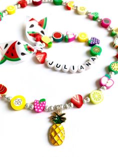 Hello everyone, welcome to my shop. This is a personalized/customized fruit stretch bracelet and necklace set for little girls. Perfect for girls as everyday summer jewelry. I will choose random fruits and ribbons to make your bracelet, I will always try to get as close as possible to original but stock may vary. I will need to know the name of your child (leave me a note at checkout section) and your child's wrist. (in inch- find your size in the menu) Can be made without the ribbon, leave me a Fun Summer Necklaces For Gifts, Colorful Fun Summer Jewelry, Playful Colorful Jewelry For Birthday, Colorful Playful Birthday Jewelry, Personalized Playful Rainbow Jewelry, Cute Adjustable Summer Jewelry, Cute Summer Jewelry For Birthday, Playful Personalized Rainbow Jewelry, Playful Summer Jewelry For Gifts