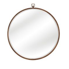 a round mirror hanging on the wall with an iron frame and metal ring around it