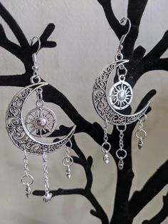 A gorgeous pair of earrings featuring earth's surrounding celestial bodies: the moon, the sun, and the stars. Choose between silver as pictured or bronze! Handmade Adjustable Alloy Earrings, Celestial Sun And Moon Dangle Jewelry, Celestial Moon Phase Moon Earrings, Celestial Style Silver Metal Jewelry, Adjustable Sun And Moon Design Drop Earrings, Celestial Nickel-free Adjustable Earrings, Celestial Nickel-free Earrings, Adjustable Celestial Nickel-free Earrings, Silver Moon-shaped Festival Jewelry