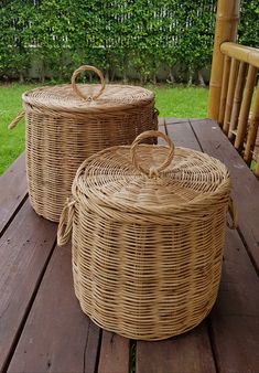 two wicker baskets sitting on top of a wooden table