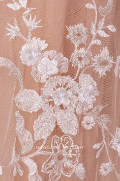 the back of a wedding dress with flowers on it