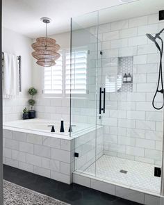 a bathroom with white tile and black accents